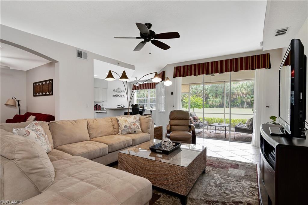 Tiled living area featuring ceiling fan