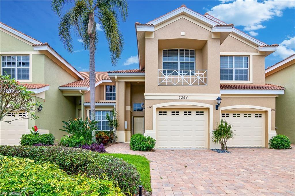 Mediterranean / spanish home with stucco siding, a tile roof, and an attached garage
