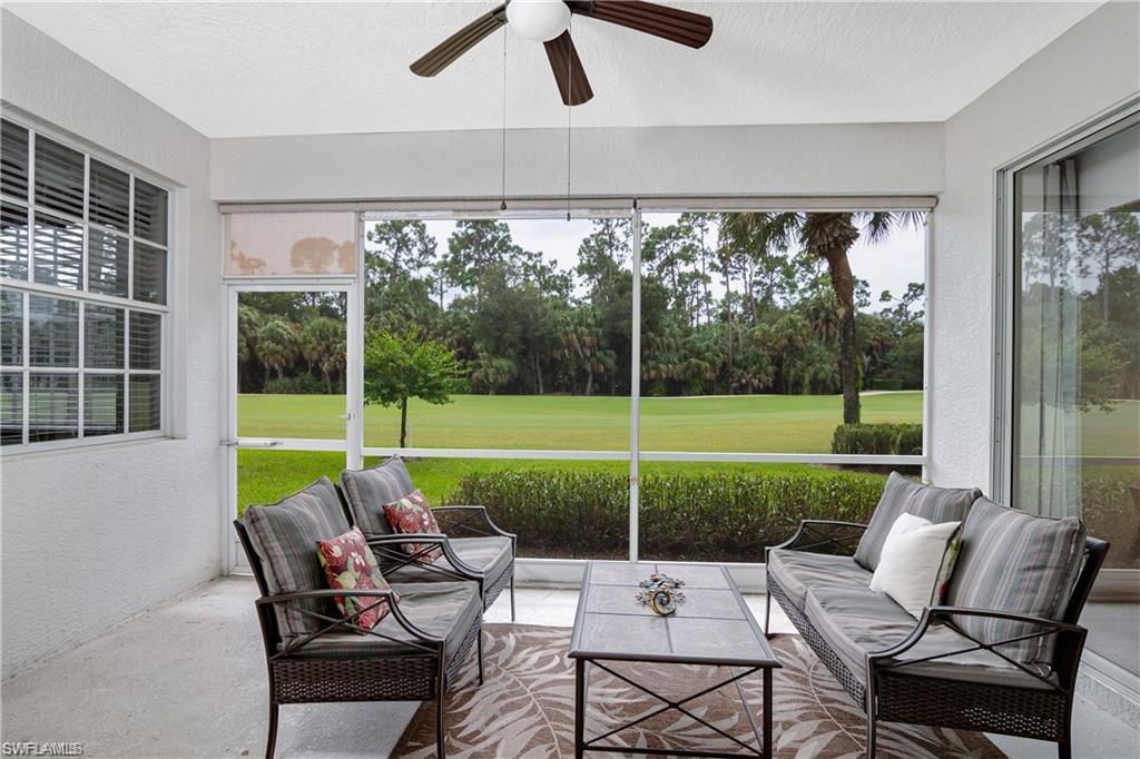 Sunroom / solarium featuring view of scattered trees