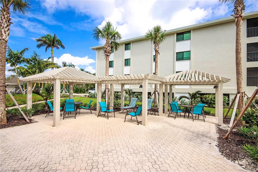 View of community with a pergola, a patio area, and outdoor dining space