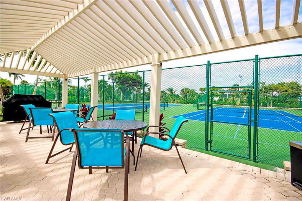 View of patio with a tennis court, area for grilling, a pergola, and outdoor dining space