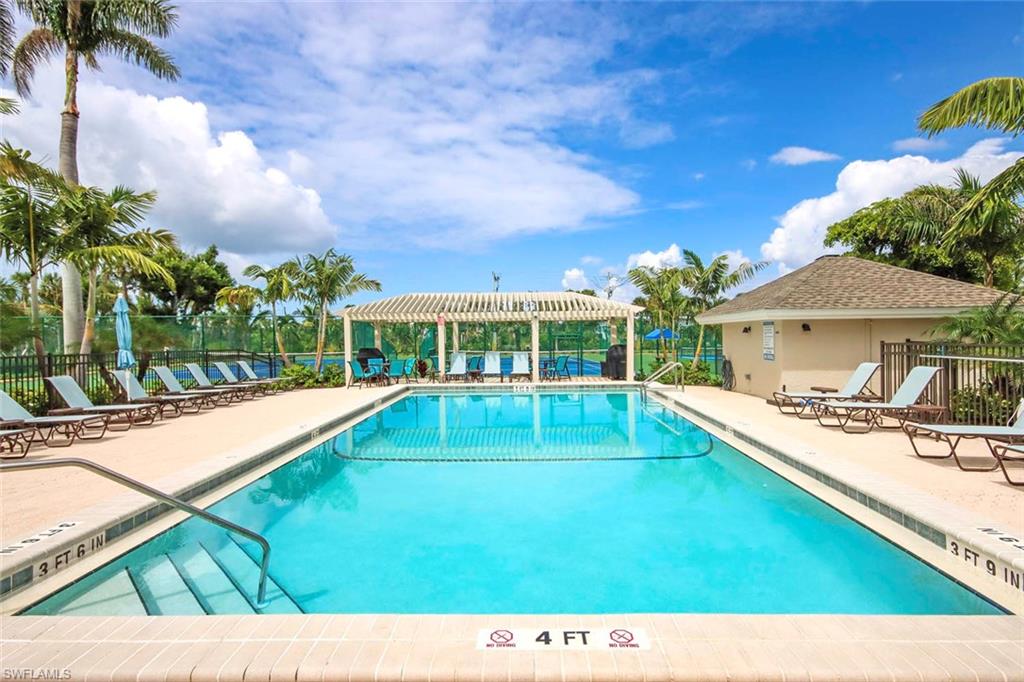 Community pool featuring a patio and a pergola