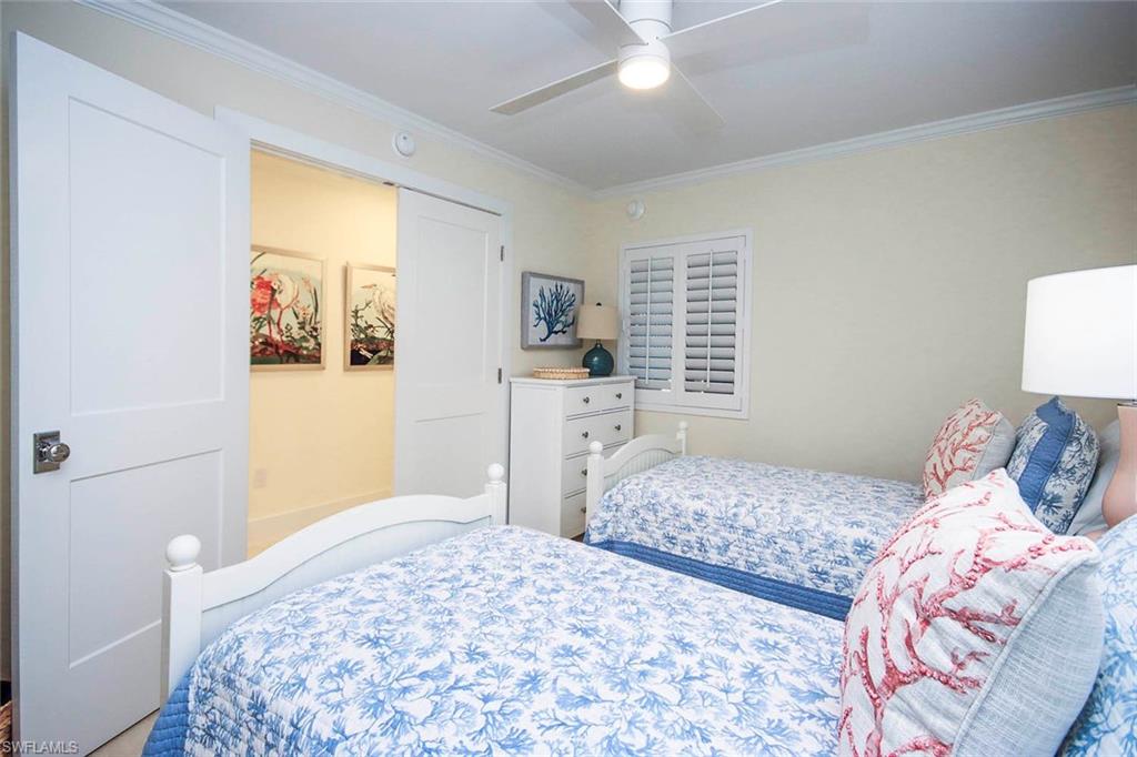 Bedroom with crown molding and a ceiling fan