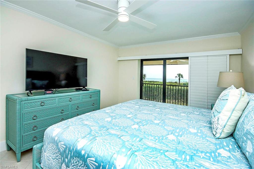 Bedroom featuring access to exterior, crown molding, ceiling fan, and tile patterned floors