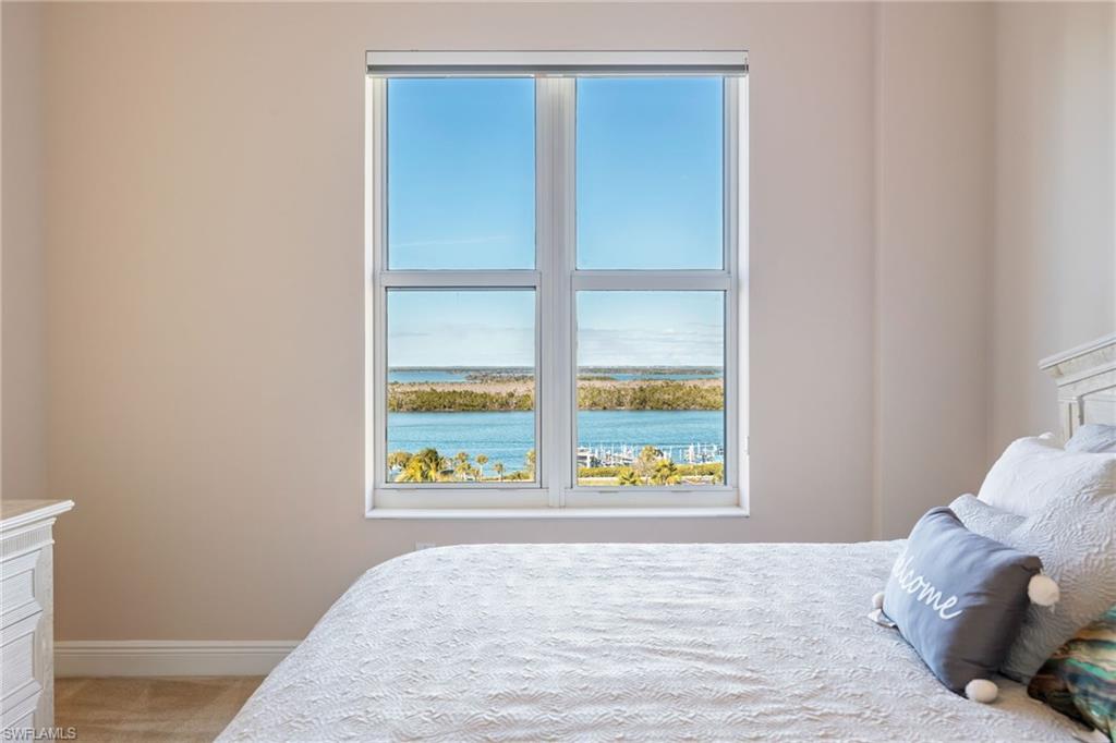 Bedroom featuring a water view and light colored carpet