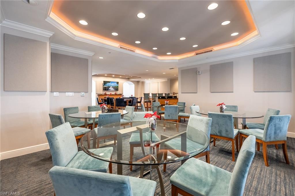 Community Dining space with ornamental molding, recessed lighting, carpet floors, and a tray ceiling