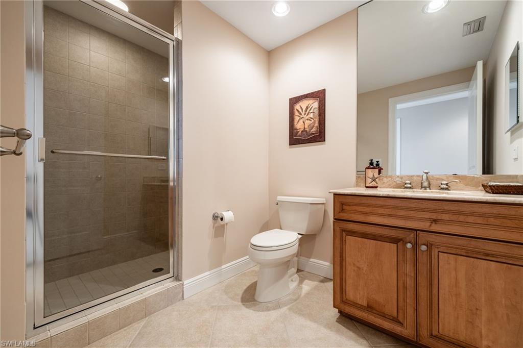 Bathroom with vanity, a shower stall, light tile patterned flooring, and recessed lighting