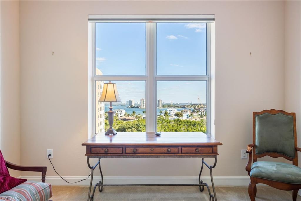 Living area with carpet floors and a city view