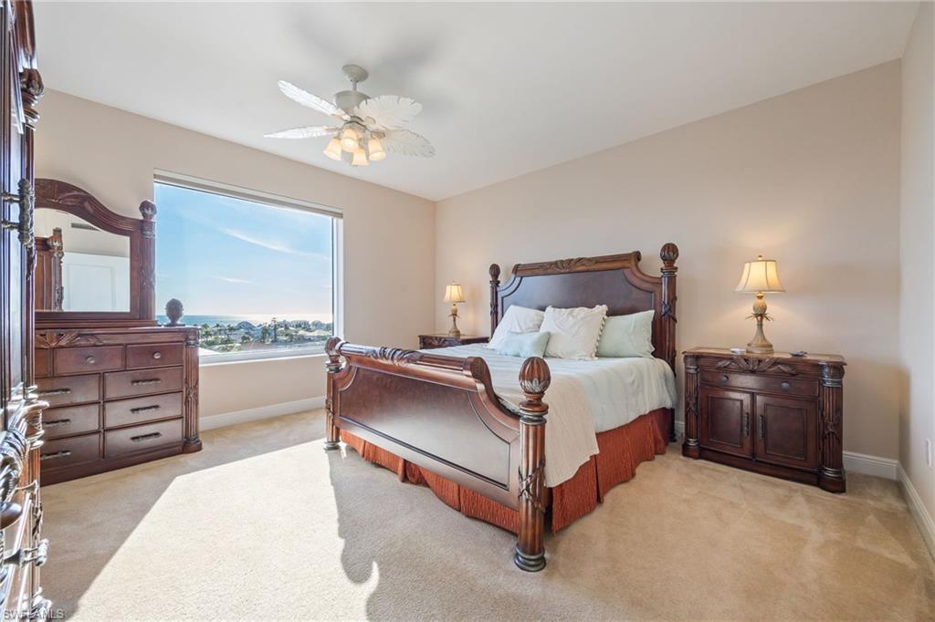 Bedroom featuring light carpet and a ceiling fan
