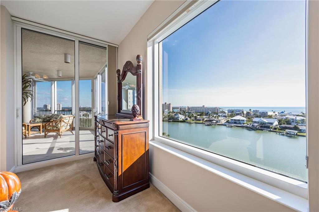 Balcony with a water view and a view of city
