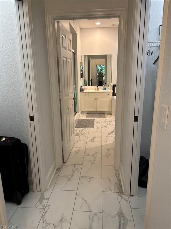Bathroom featuring light marble finish flooring and vanity