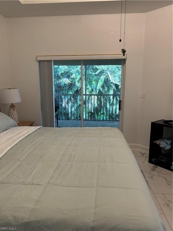 Bedroom featuring marble look tiles, access to exterior, and multiple windows