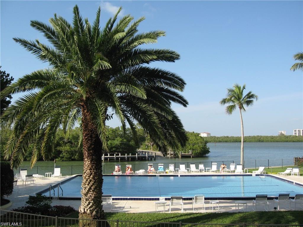Community pool with a patio and a water view