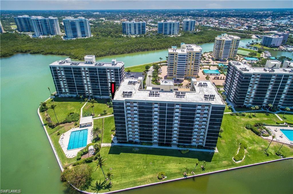 View of urban area with a large body of water and a pool