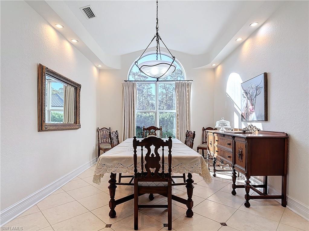 Dining room with a textured wall and light tile patterned floors