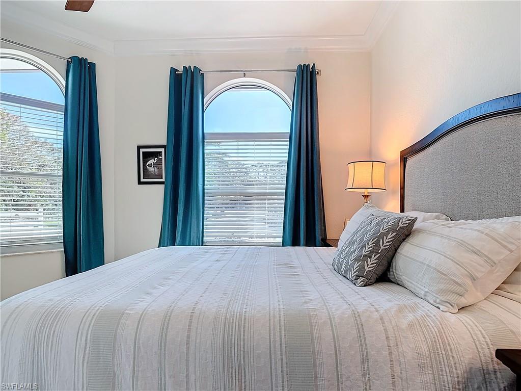 Bedroom featuring ceiling fan and crown molding