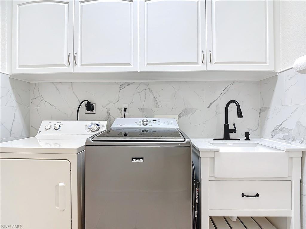 Washroom with cabinet space and washer and dryer