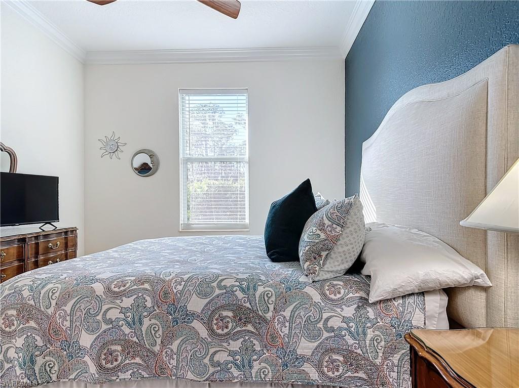 Bedroom featuring ceiling fan and crown molding