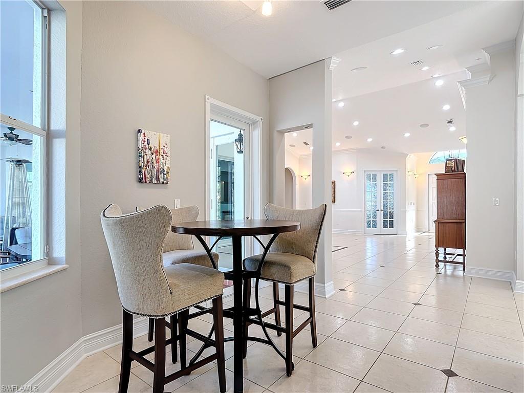 Dining room featuring light tile patterned flooring and recessed lighting