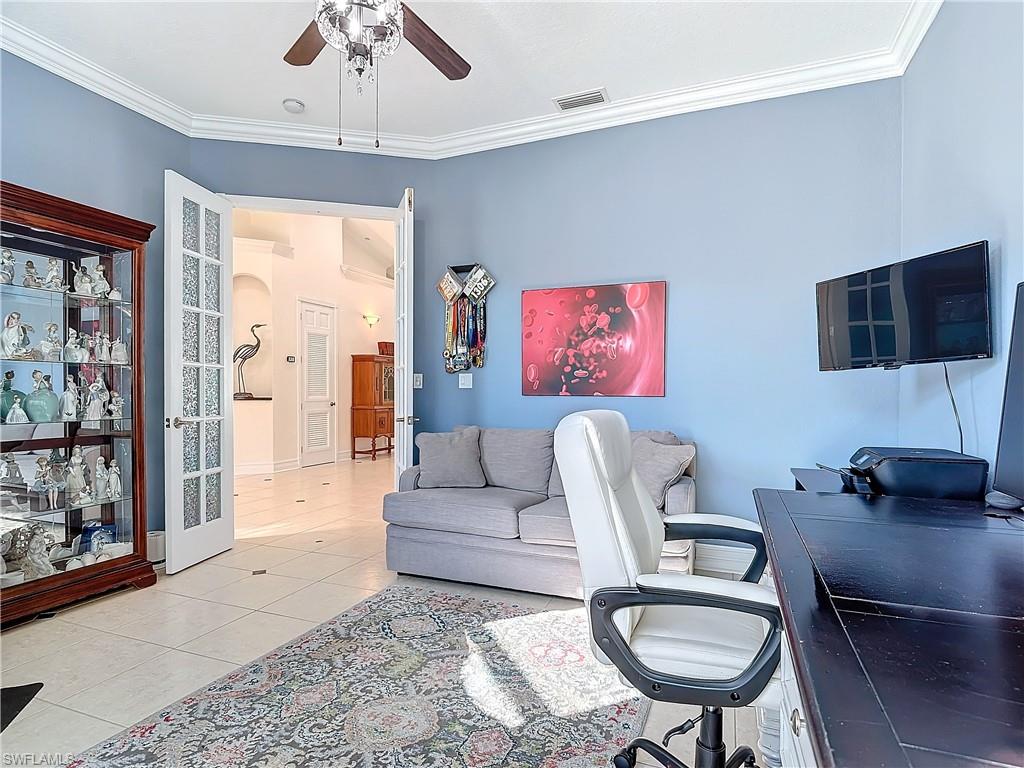 Tiled office featuring crown molding and a ceiling fan
