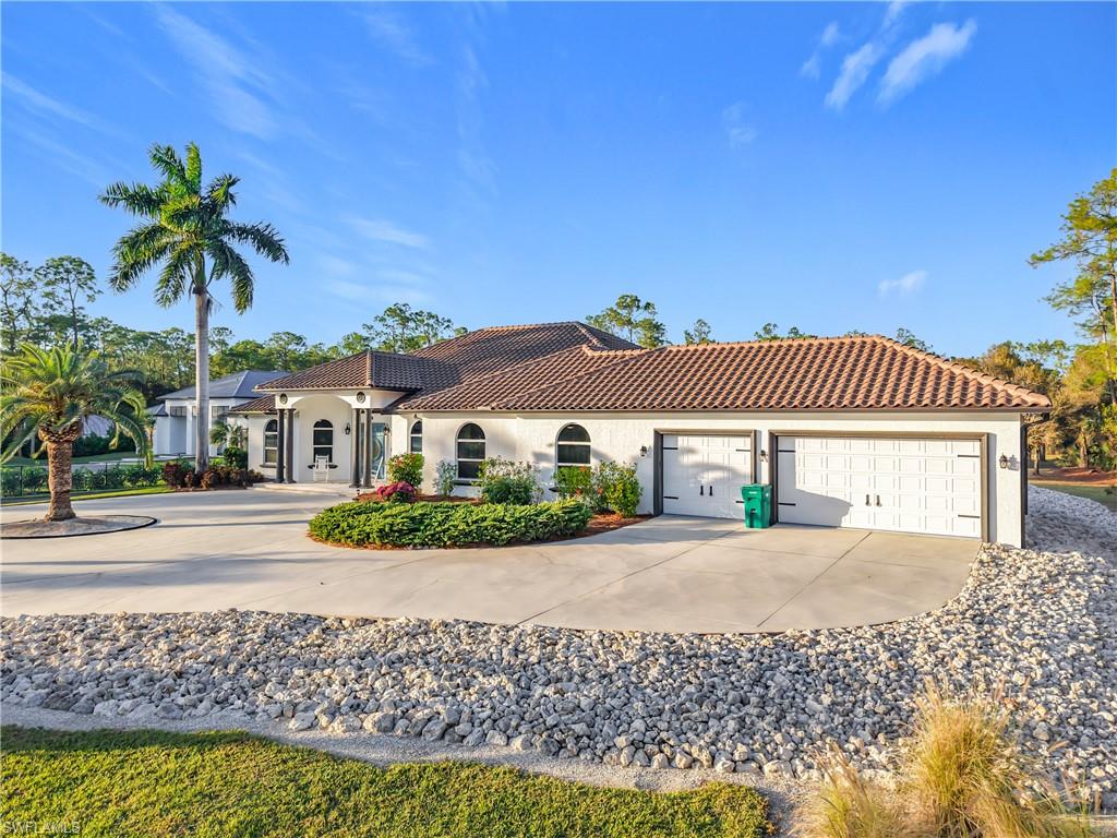 Mediterranean / spanish-style house featuring driveway, stucco siding, a tile roof, and a garage