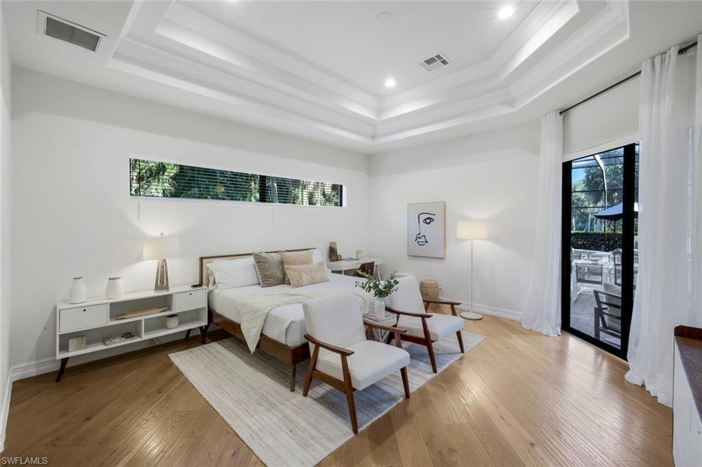 Bedroom with access to outside, wood-type flooring, recessed lighting, and crown molding