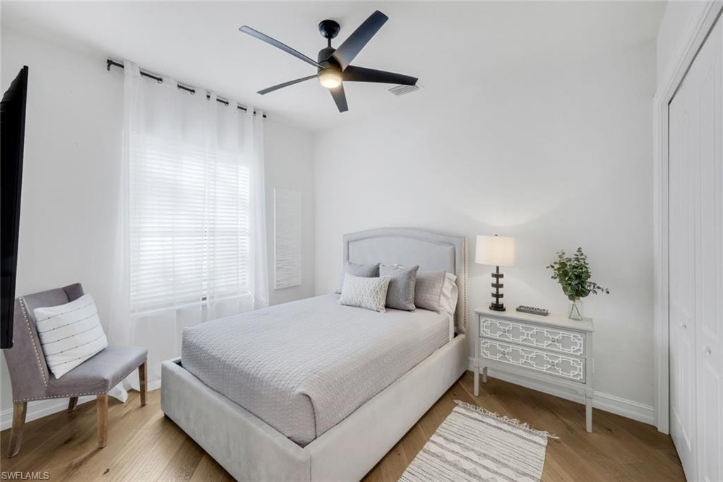 Bedroom featuring a closet, a ceiling fan, and light wood-style flooring