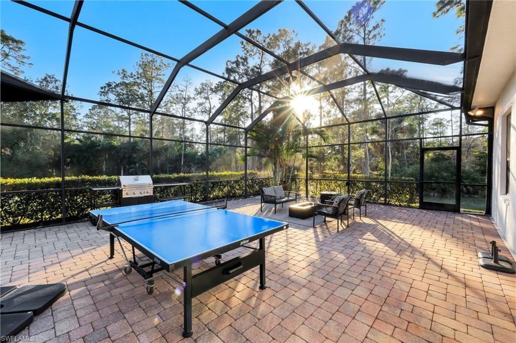 View of patio / terrace with glass enclosure, outdoor lounge area, a sunroom, and area for grilling