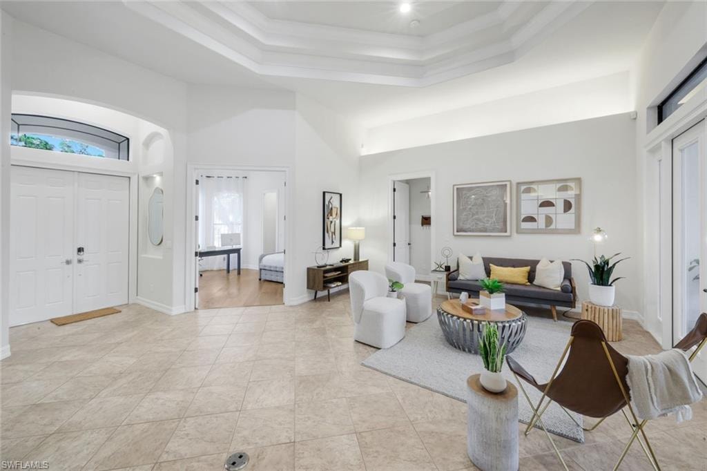 Entrance foyer with a high ceiling and baseboards
