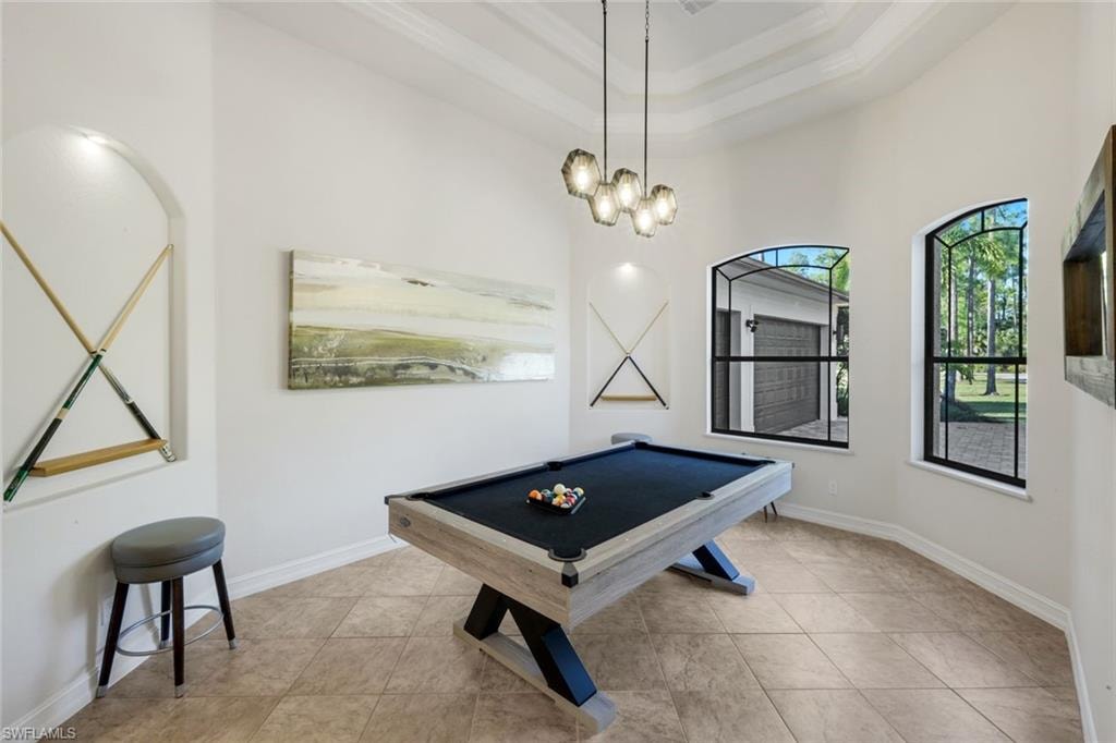 Recreation room featuring pool table, light tile patterned floors, and a raised ceiling