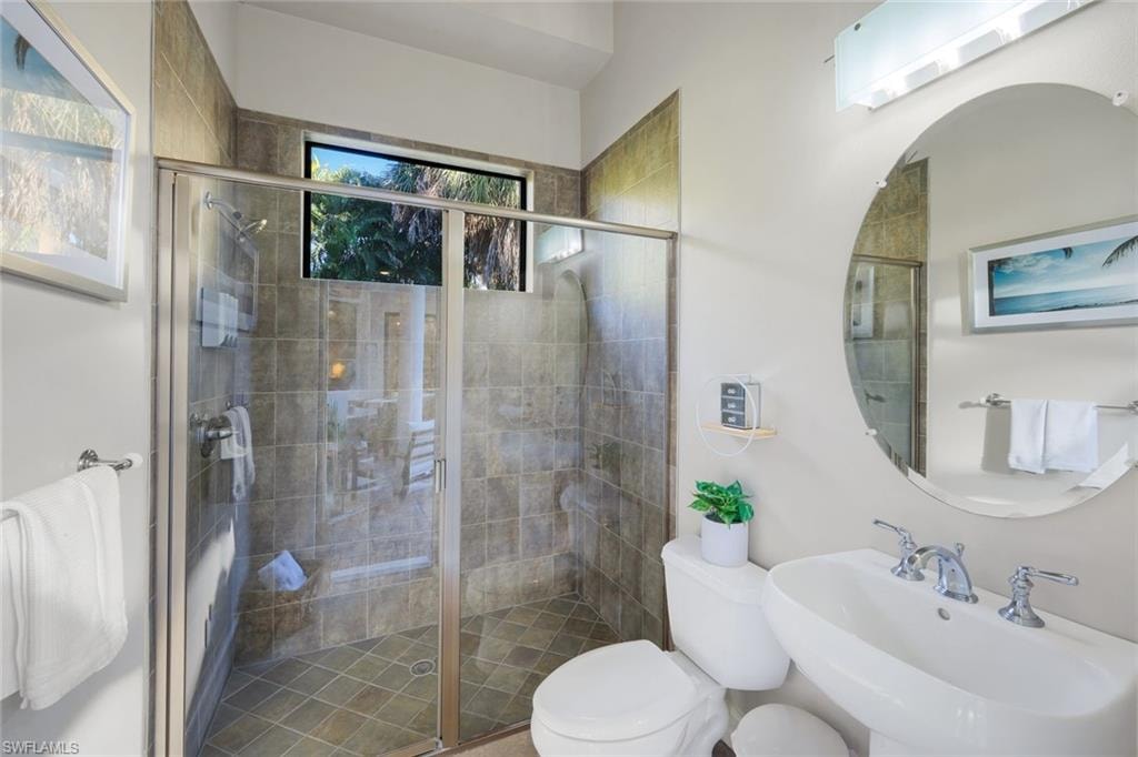Bathroom featuring toilet and a shower stall
