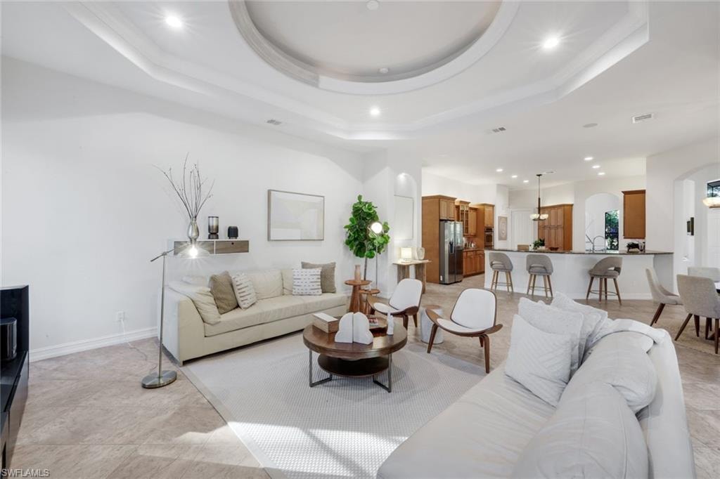 Living room featuring recessed lighting and arched walkways