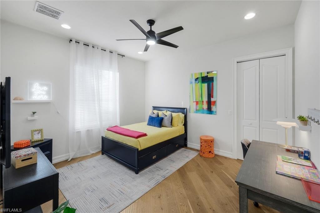 Bedroom featuring ceiling fan, light wood-type flooring, a closet, recessed lighting, and a desk