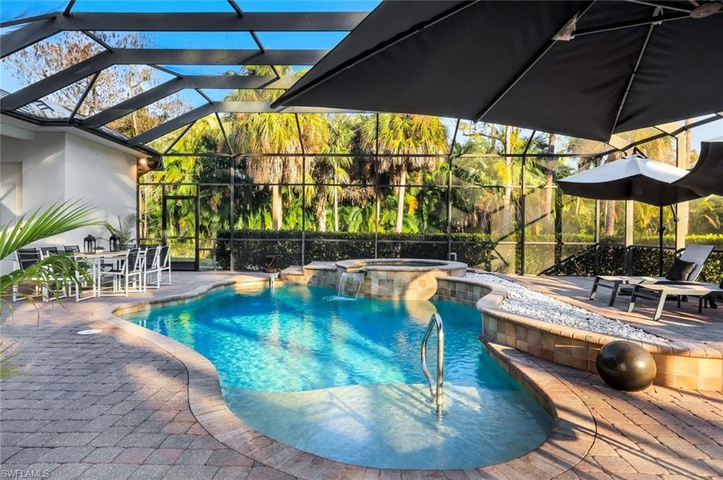 Integrated pool / spa featuring a lanai, a patio area, outdoor dining space, and a sunroom