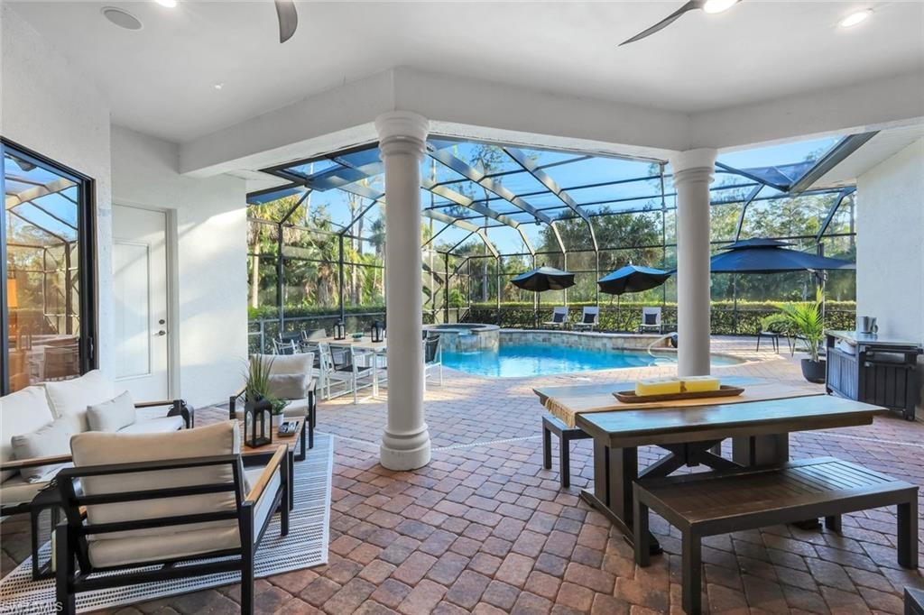 Integrated pool / spa featuring a patio area, glass enclosure, and a sunroom