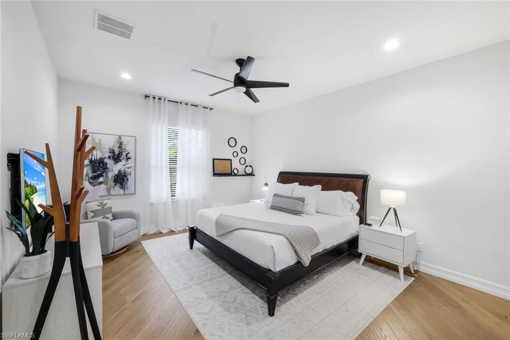 Bedroom featuring light wood-style floors, a ceiling fan, and recessed lighting