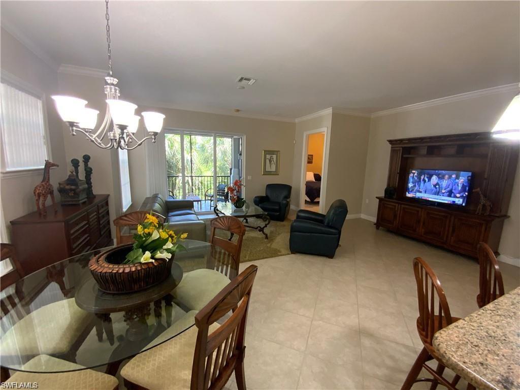Dining area with crown molding and a chandelier