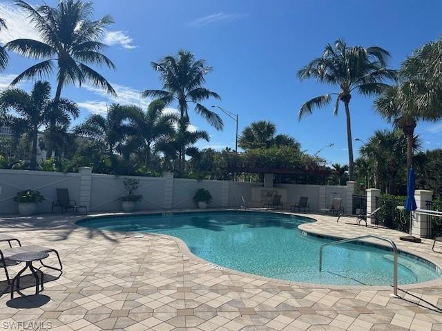 Community pool with a patio