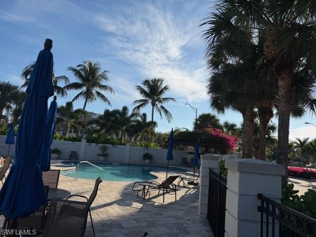 View of swimming pool with a fenced backyard and a patio