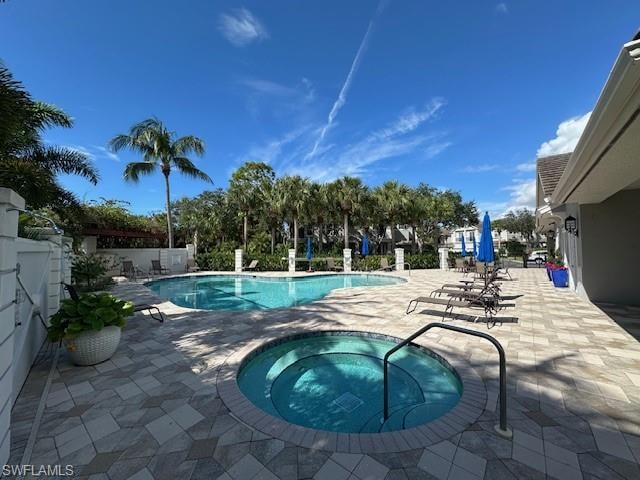 Community pool featuring a patio and a community hot tub
