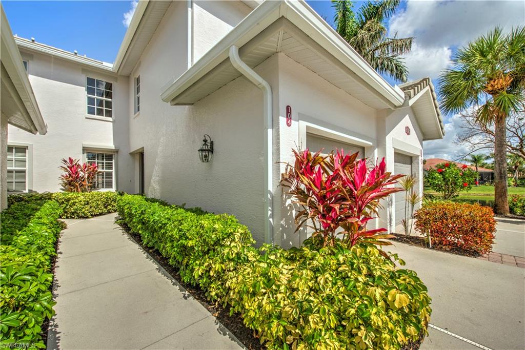 View of side of property featuring stucco siding and an attached garage