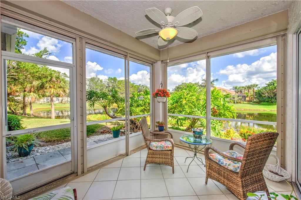 Sunroom / solarium with a water view and ceiling fan
