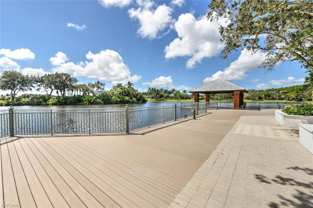 Dock area featuring a water view and view of scattered trees