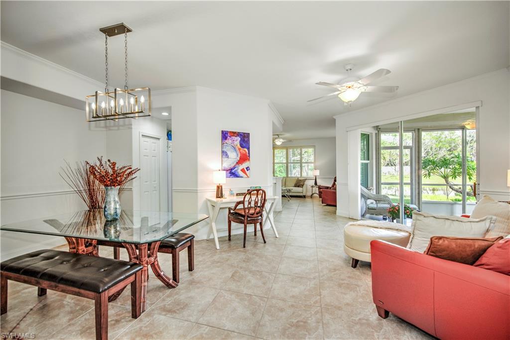 Dining space featuring crown molding, ceiling fan, and light tile patterned floors