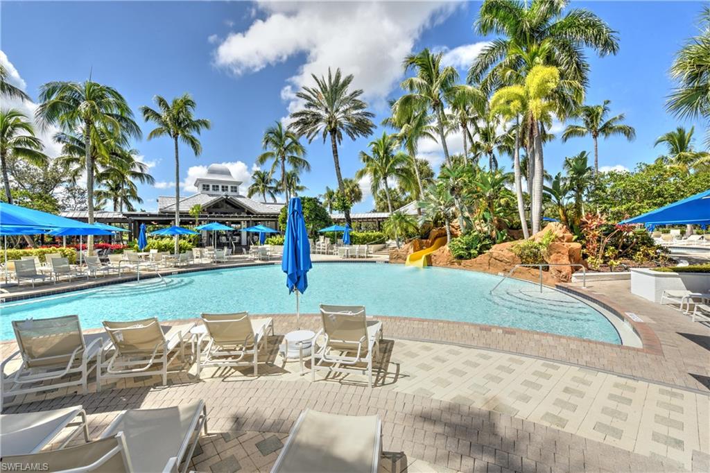 Community pool featuring a water slide and a patio area