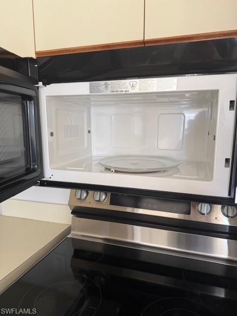 Kitchen view of range and light countertops