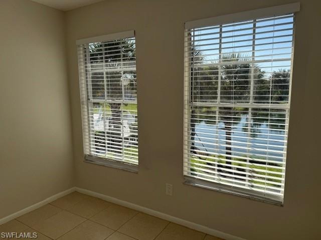 Unfurnished room with baseboards and light tile patterned floors