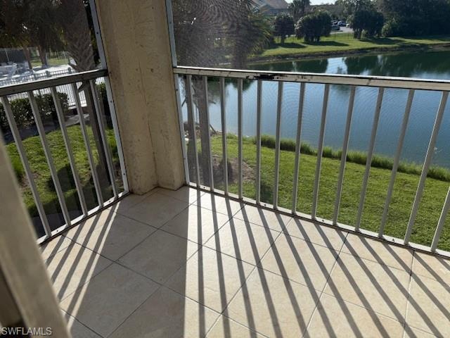 Balcony featuring a water view and a sunroom
