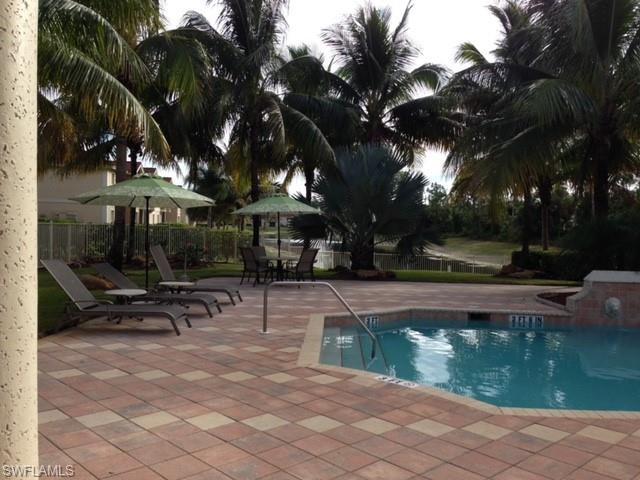 Community pool with a patio