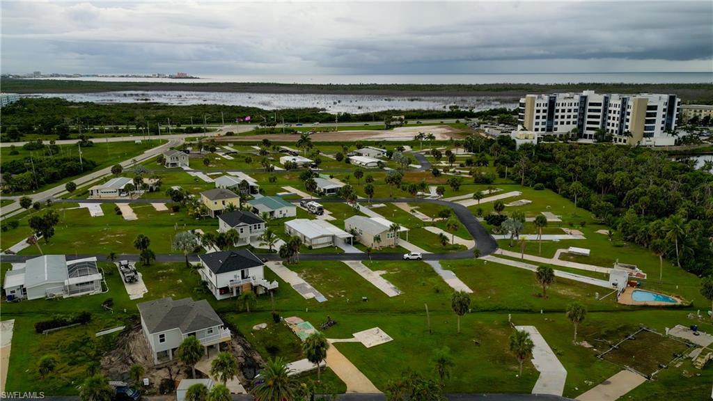 View of property location featuring a large body of water and nearby suburban area